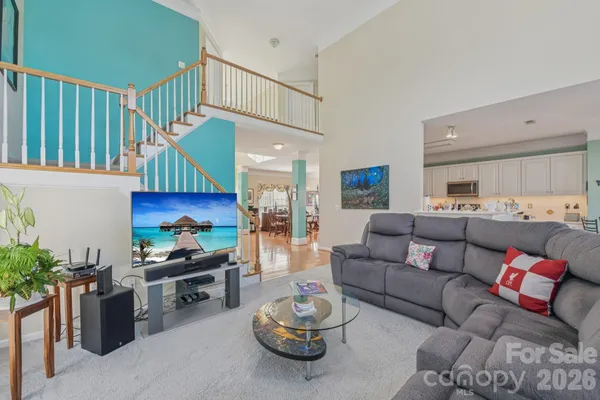 a living room with furniture a fireplace and a potted plant