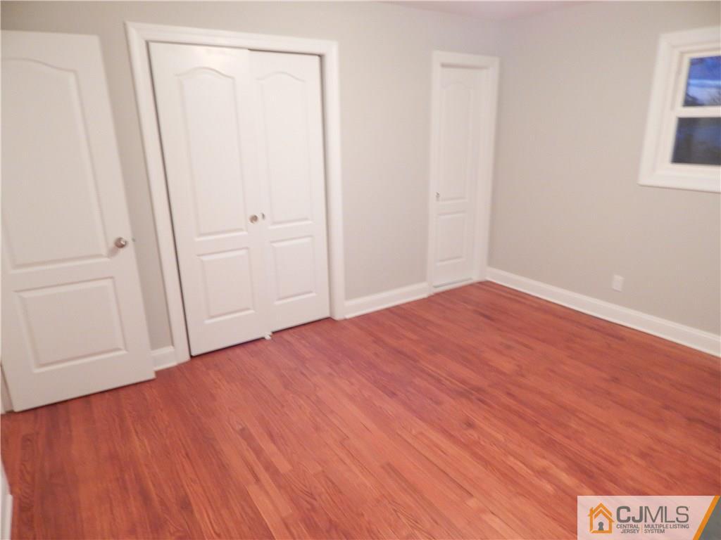 67 Princeton Road Old Bridge, NJ 08859 - Photo 14 of 24 an empty room with wooden floor and closet