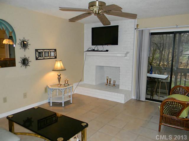 11006 Running Ridge Road, Unit 8441 Charlotte, NC 28226 - Photo 2 of 12 a living room with furniture a flat screen tv and a fireplace