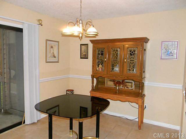11006 Running Ridge Road, Unit 8441 Charlotte, NC 28226 - Photo 3 of 12 a view of a dining room with furniture and chandelier