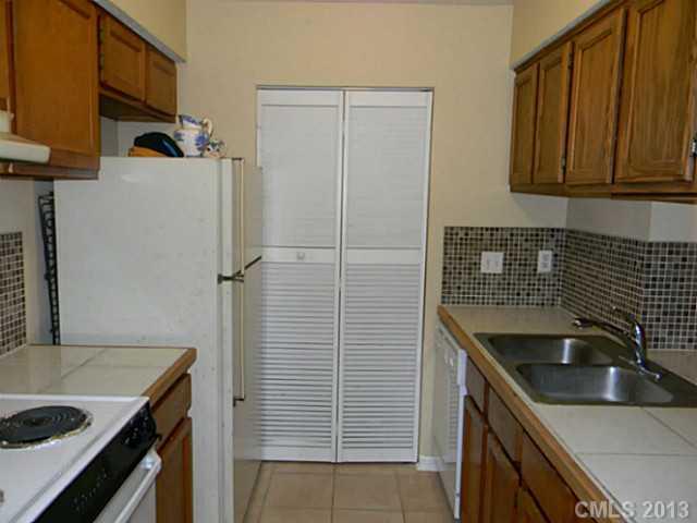 11006 Running Ridge Road, Unit 8441 Charlotte, NC 28226 - Photo 5 of 12 a kitchen with stainless steel appliances granite countertop a sink stove and refrigerator