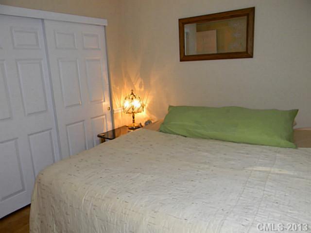 11006 Running Ridge Road, Unit 8441 Charlotte, NC 28226 - Photo 7 of 12 a bedroom with a bed and a window