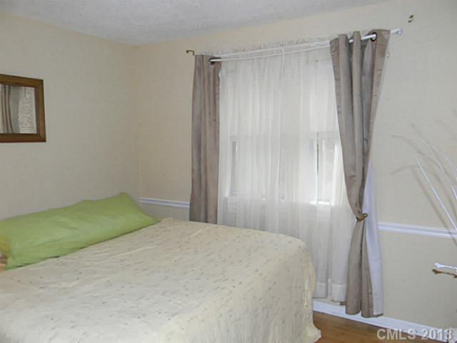 11006 Running Ridge Road, Unit 8441 Charlotte, NC 28226 - Photo 9 of 12 a bedroom with a bed and a shower