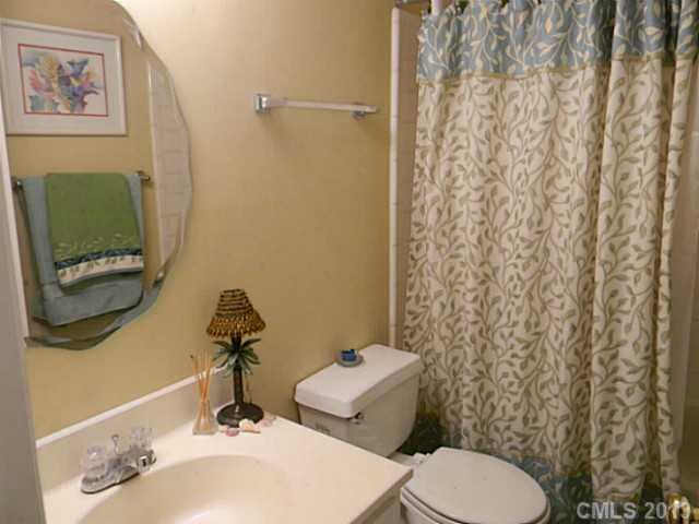 11006 Running Ridge Road, Unit 8441 Charlotte, NC 28226 - Photo 10 of 12 a bathroom with a toilet sink and mirror