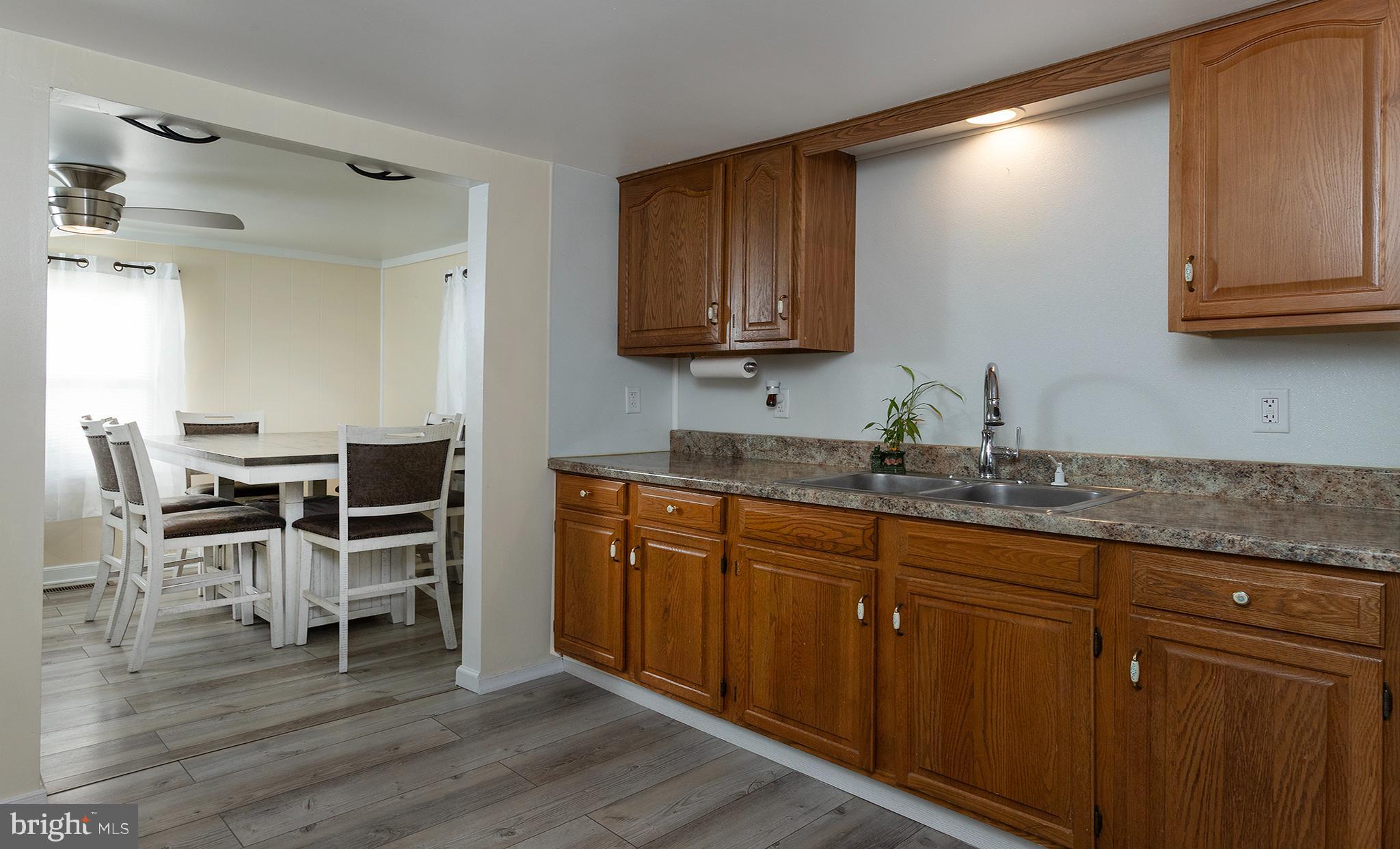 1102 Rana Villa Avenue Camp Hill, PA 17011 - Photo 14 of 41 a kitchen with granite countertop wooden cabinets chairs and entryway
