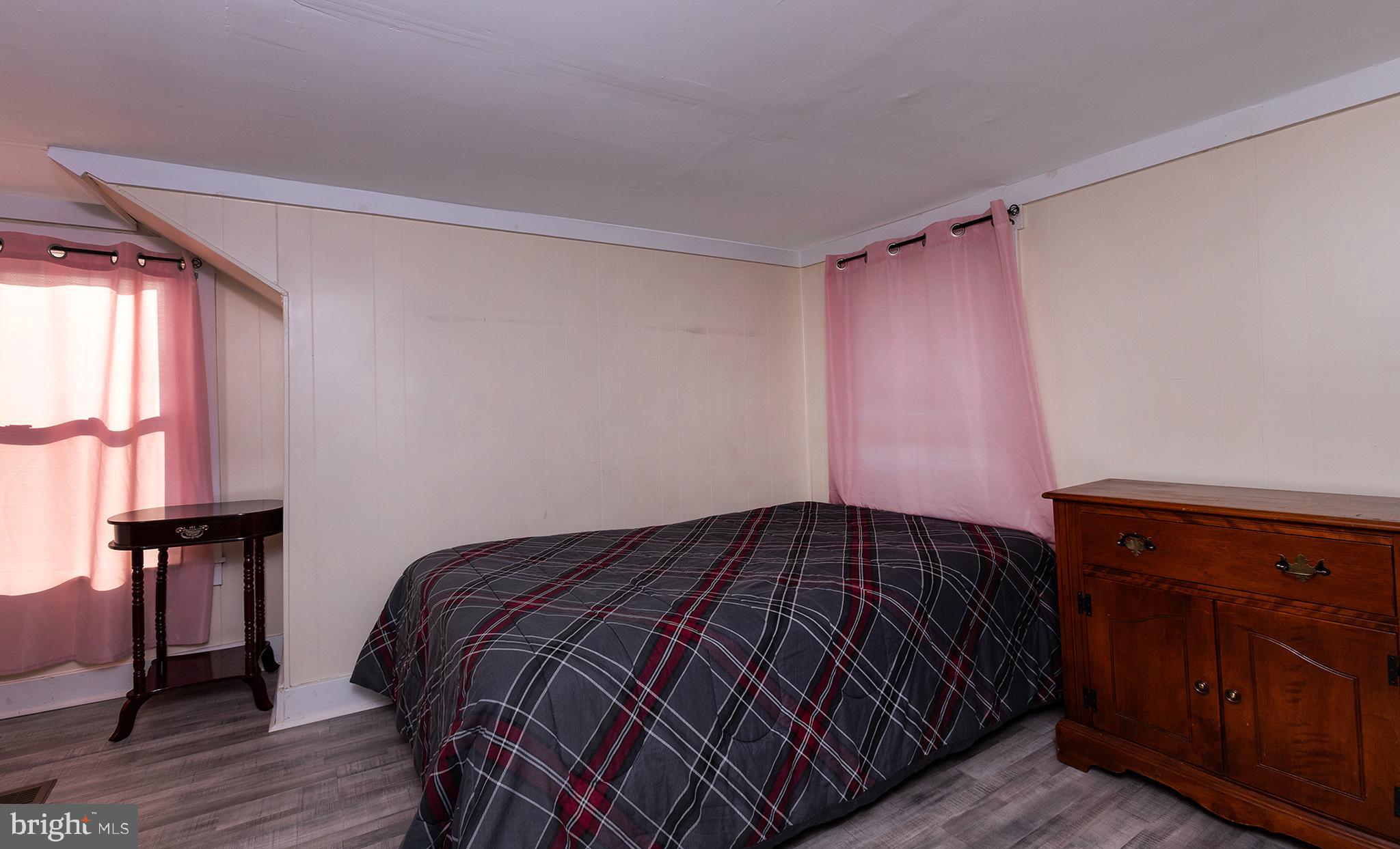 1102 Rana Villa Avenue Camp Hill, PA 17011 - Photo 26 of 41 a bedroom with a bed and wooden floor