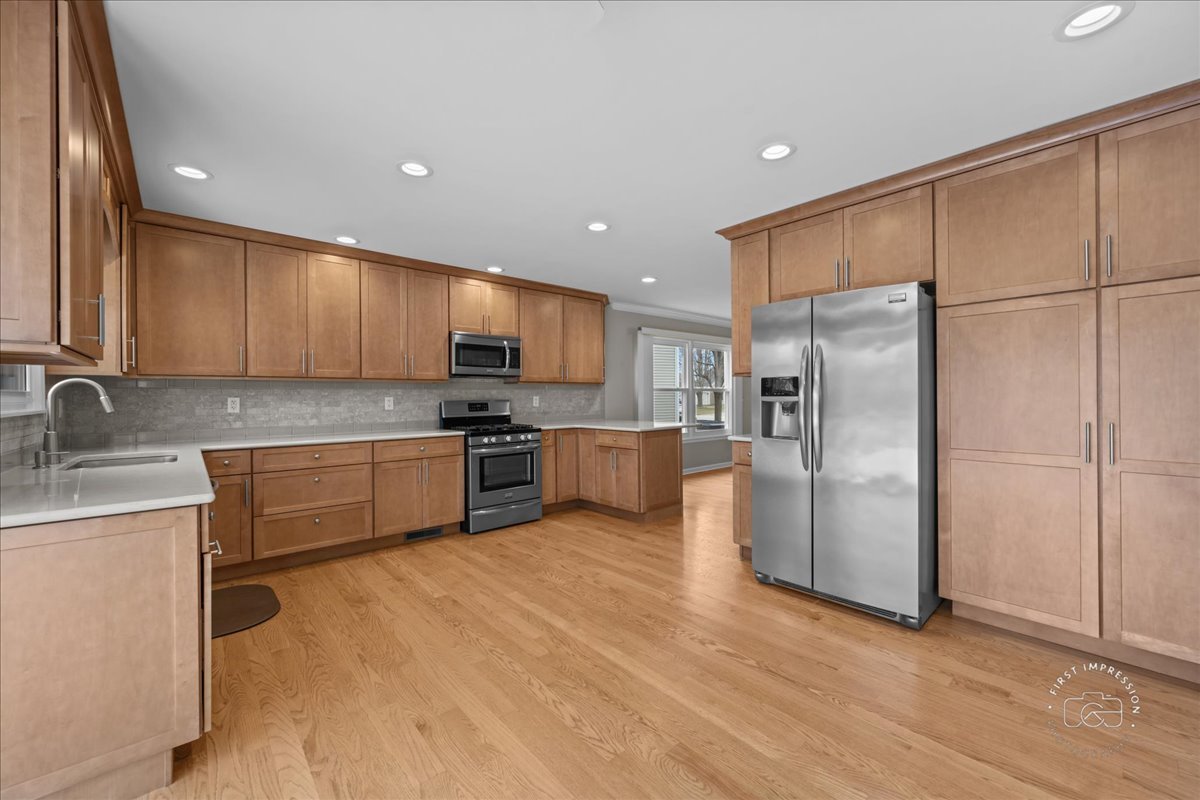 32 Dunham Place St. Charles, IL 60174 - Photo 16 of 56 a kitchen with stainless steel appliances granite countertop a refrigerator sink and cabinets