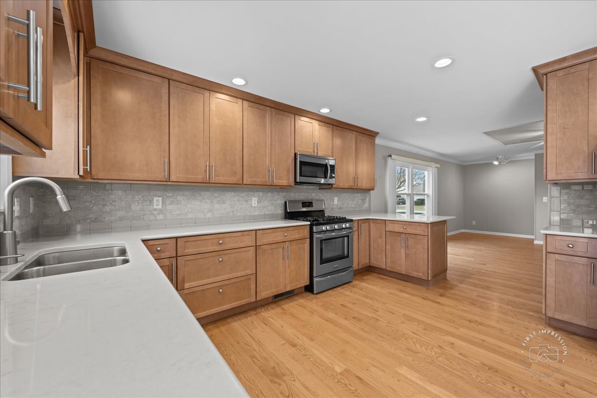 32 Dunham Place St. Charles, IL 60174 - Photo 17 of 56 a kitchen with stainless steel appliances granite countertop a sink dishwasher stove top oven and cabinets with wooden floor