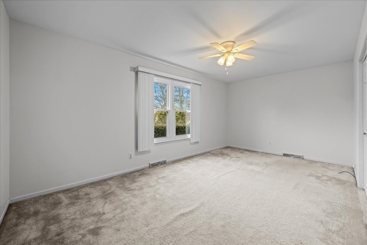 32 Dunham Place St. Charles, IL 60174 - Photo 27 of 56 an empty room with a window and a fan