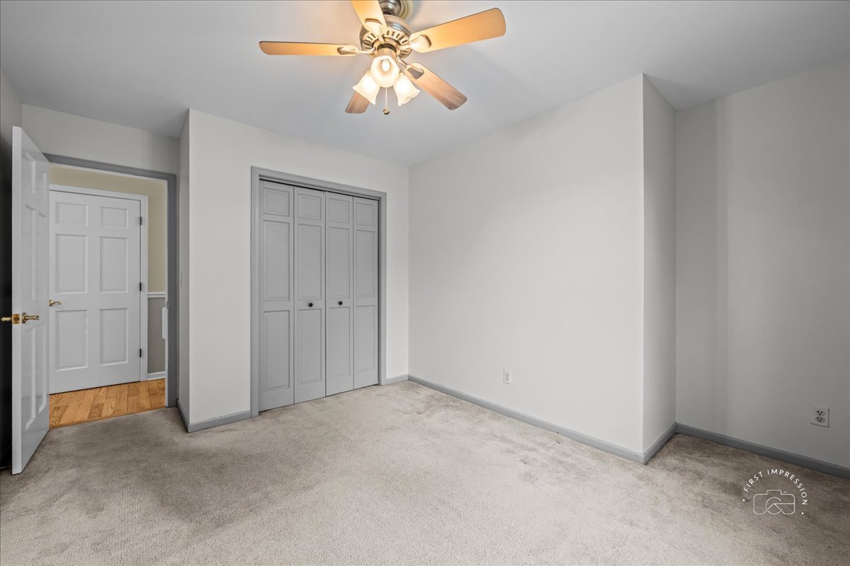 32 Dunham Place St. Charles, IL 60174 - Photo 30 of 56 an empty room with a chandelier fan and closet area