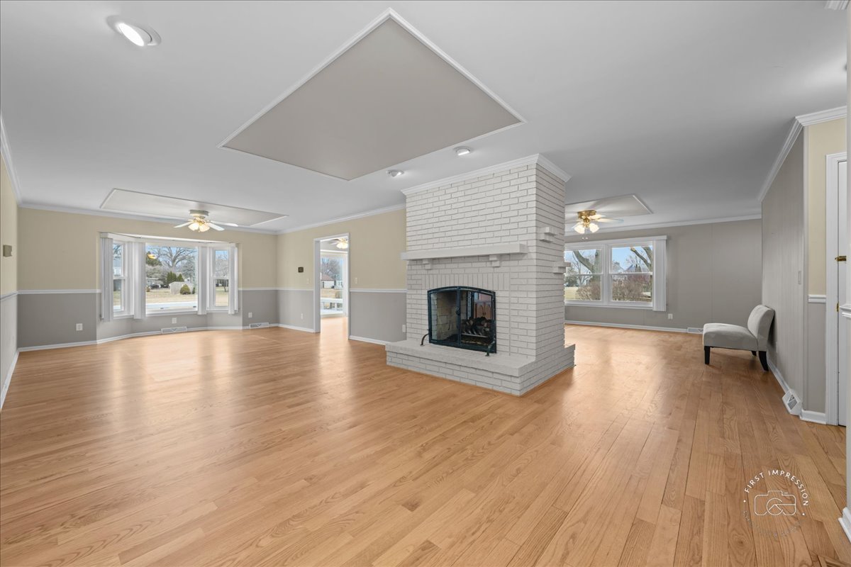 32 Dunham Place St. Charles, IL 60174 - Photo 4 of 56 a view of empty room with wooden floor and fireplace