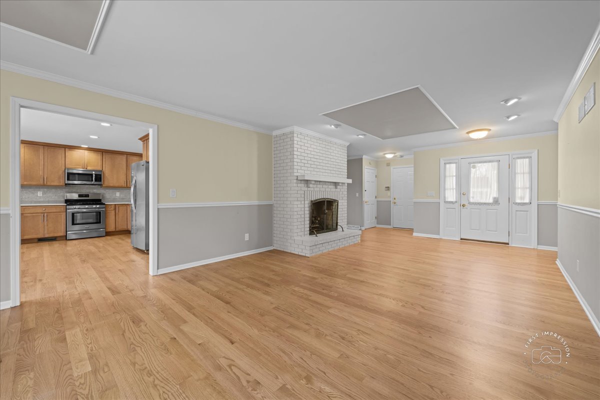 32 Dunham Place St. Charles, IL 60174 - Photo 6 of 56 a view of empty room with wooden floor and a kitchen