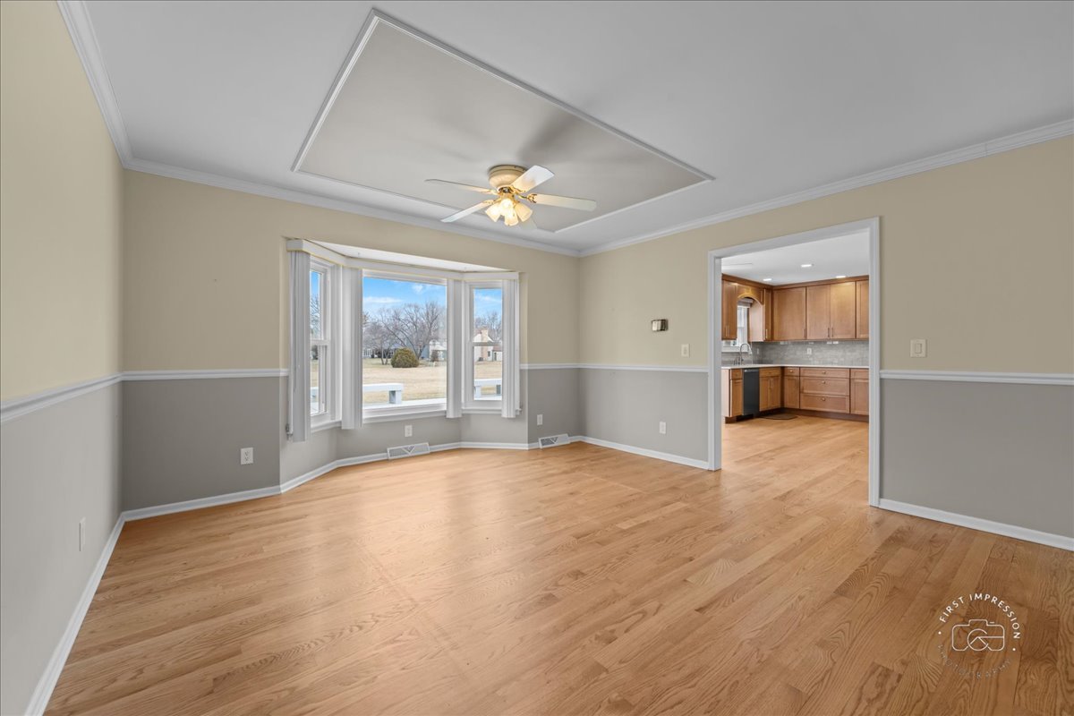 32 Dunham Place St. Charles, IL 60174 - Photo 7 of 56 a view of an empty room with a window and wooden floor