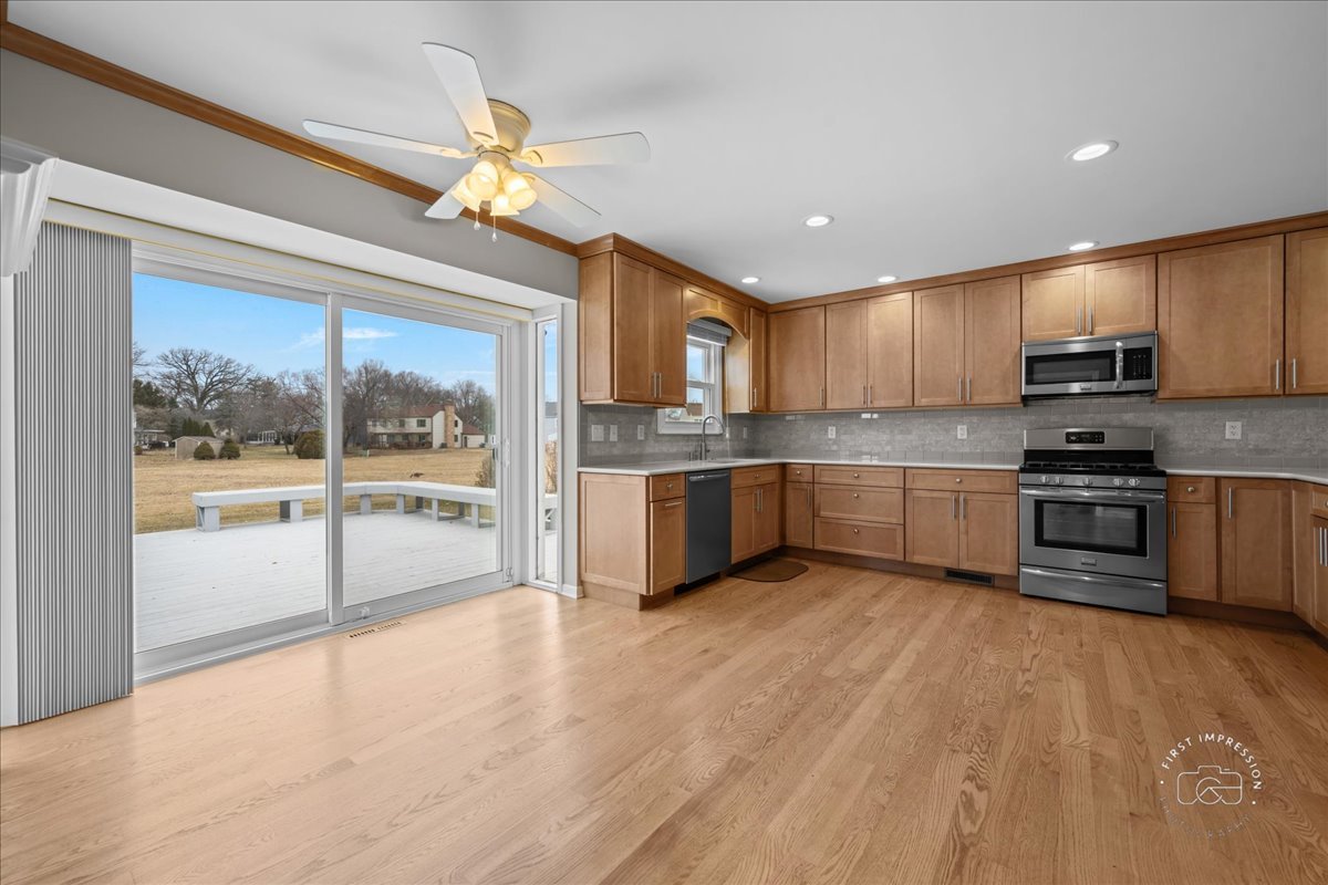 32 Dunham Place St. Charles, IL 60174 - Photo 9 of 56 a kitchen with stainless steel appliances a sink a stove a refrigerator cabinets and a large window