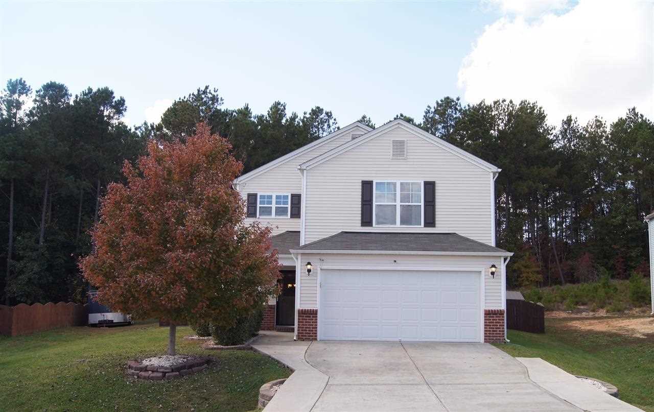3029 Varcroft Road Knightdale, NC 27545 - Photo 1 of 25 a view of a white house with a yard potted plants and a large tree