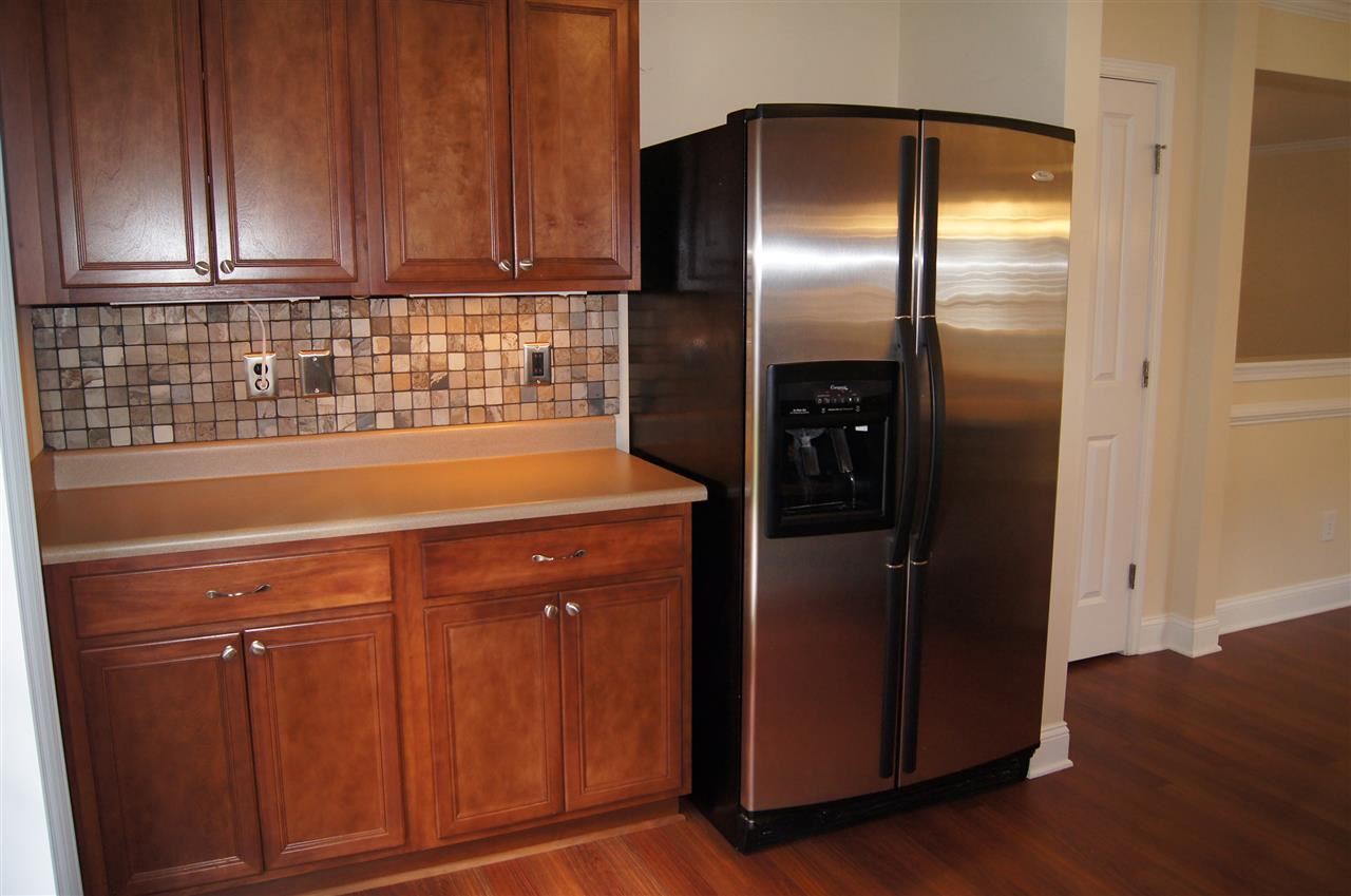 3029 Varcroft Road Knightdale, NC 27545 - Photo 11 of 25 a kitchen with a refrigerator and cabinets