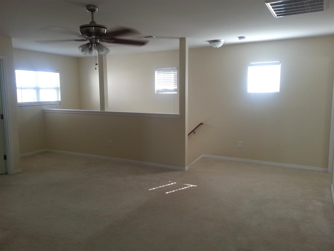 3029 Varcroft Road Knightdale, NC 27545 - Photo 16 of 25 en empty room with windows and ceiling fan