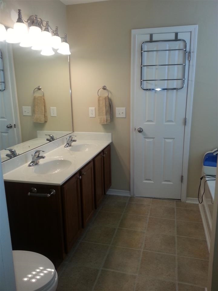 3029 Varcroft Road Knightdale, NC 27545 - Photo 18 of 25 a bathroom with a sink a toilet and a mirror