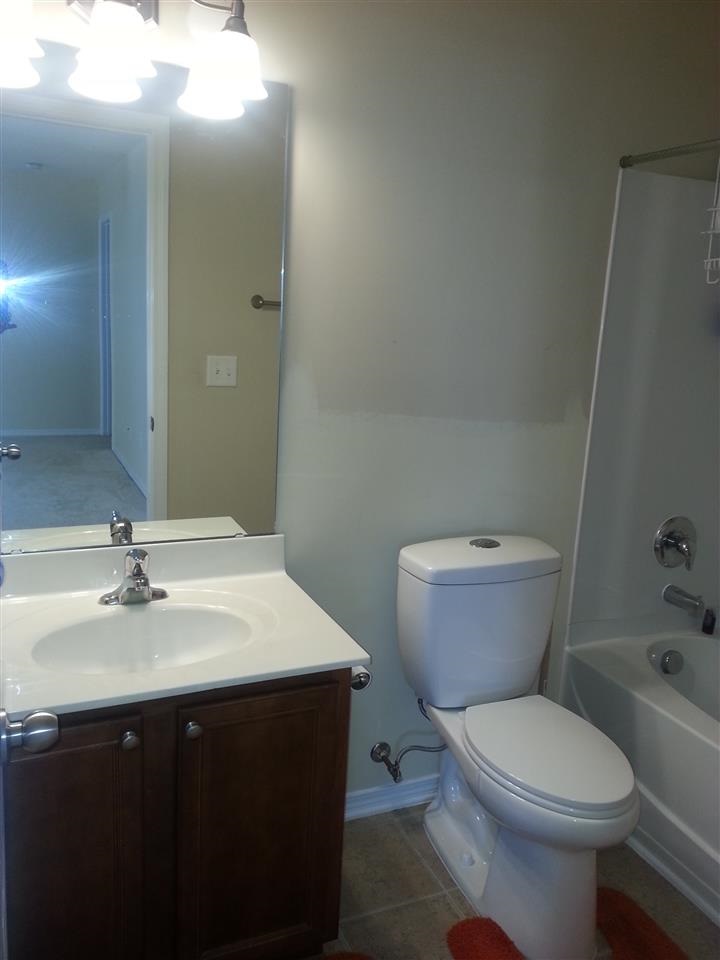 3029 Varcroft Road Knightdale, NC 27545 - Photo 21 of 25 a bathroom with a sink vanity mirror and toilet
