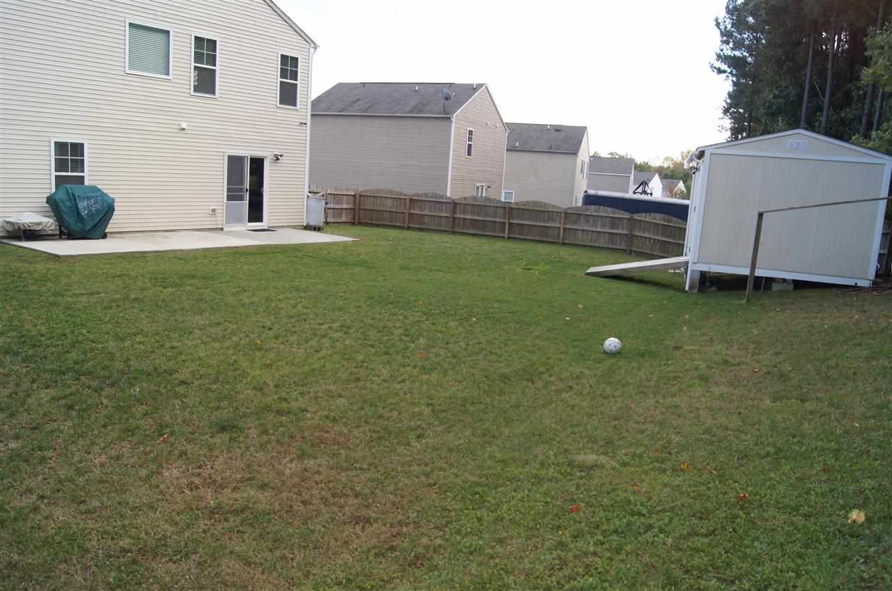 3029 Varcroft Road Knightdale, NC 27545 - Photo 23 of 25 a backyard of a house with table and chairs