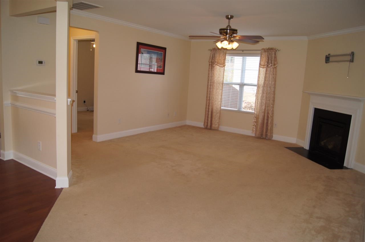 3029 Varcroft Road Knightdale, NC 27545 - Photo 7 of 25 an empty room with windows and fireplace