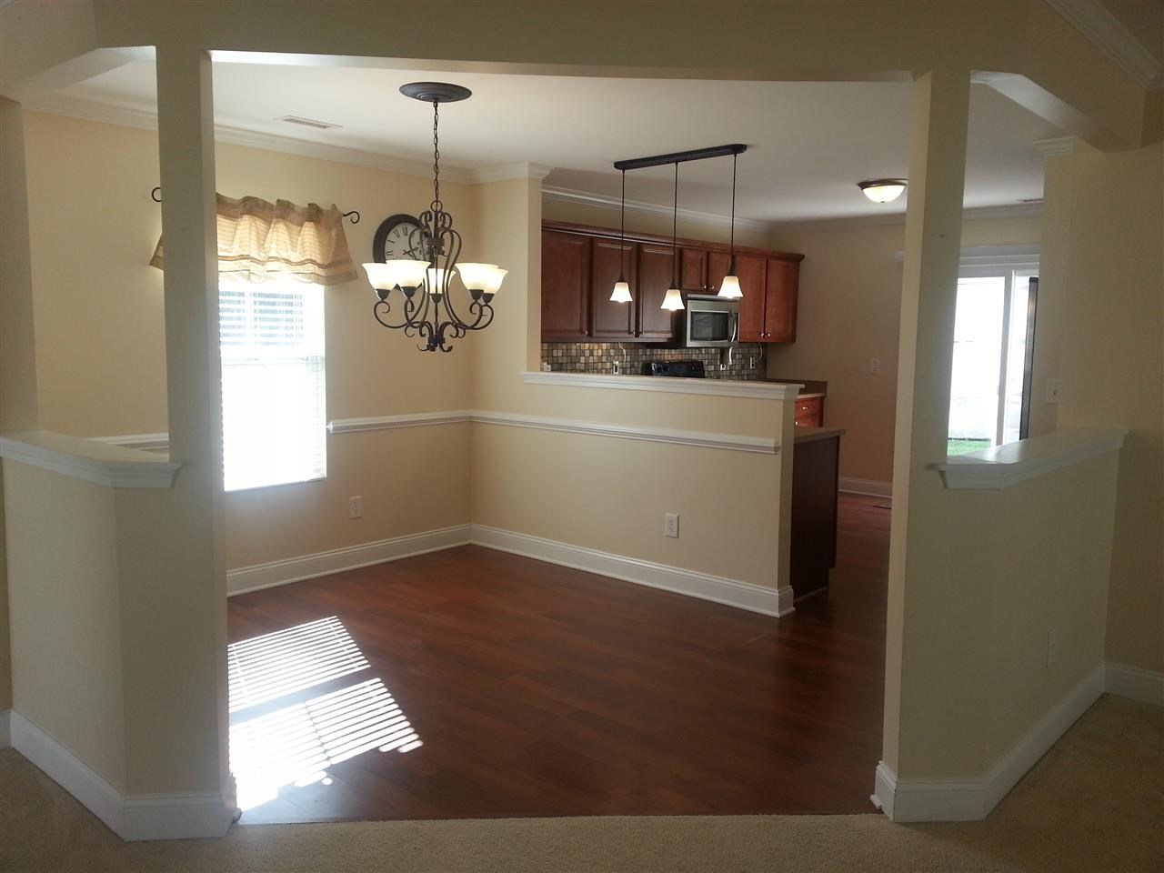 3029 Varcroft Road Knightdale, NC 27545 - Photo 8 of 25 a room with kitchen island and wooden floor