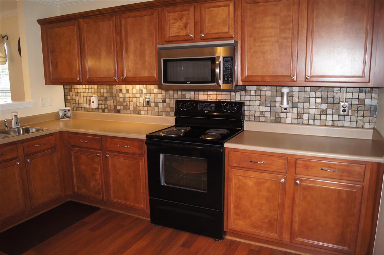 3029 Varcroft Road Knightdale, NC 27545 - Photo 10 of 25 a kitchen with granite countertop wooden cabinets and stainless steel appliances