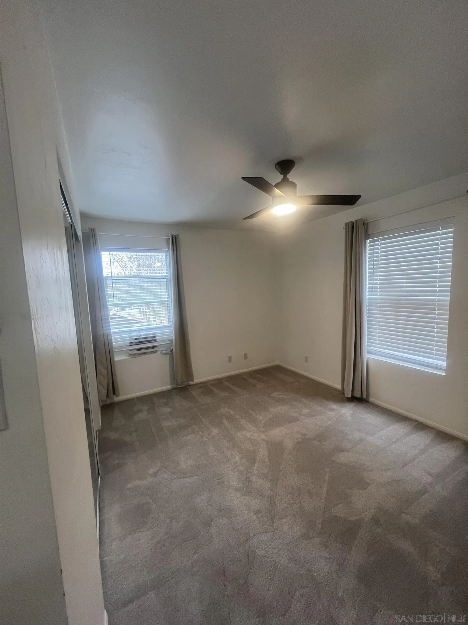 1927 3rd Street Julian, CA 92036 - Photo 9 of 11 an empty room with windows and refrigerator