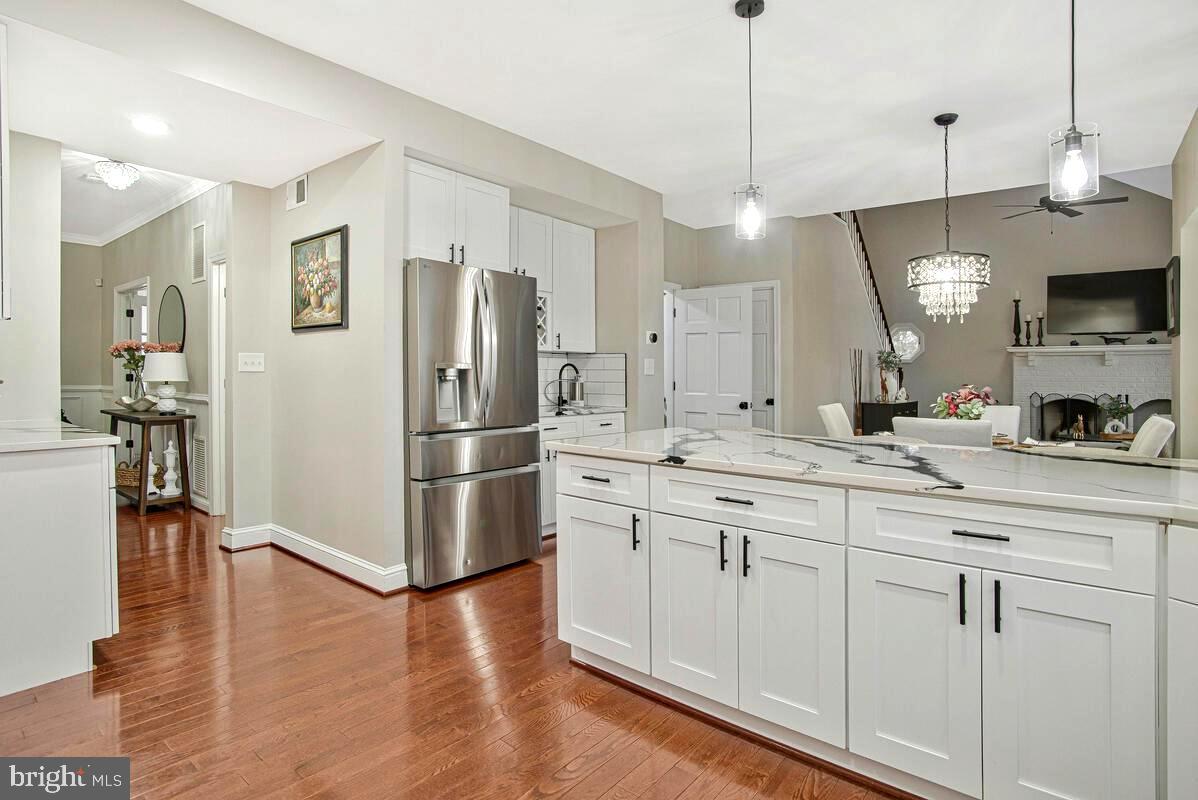 8241 Surratts Road Clinton, MD 20735 - Photo 15 of 55 a kitchen with stainless steel appliances granite countertop a refrigerator a sink and white cabinets