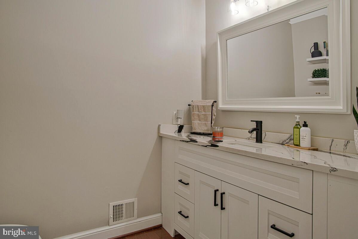 8241 Surratts Road Clinton, MD 20735 - Photo 18 of 55 a bathroom with a sink and a mirror