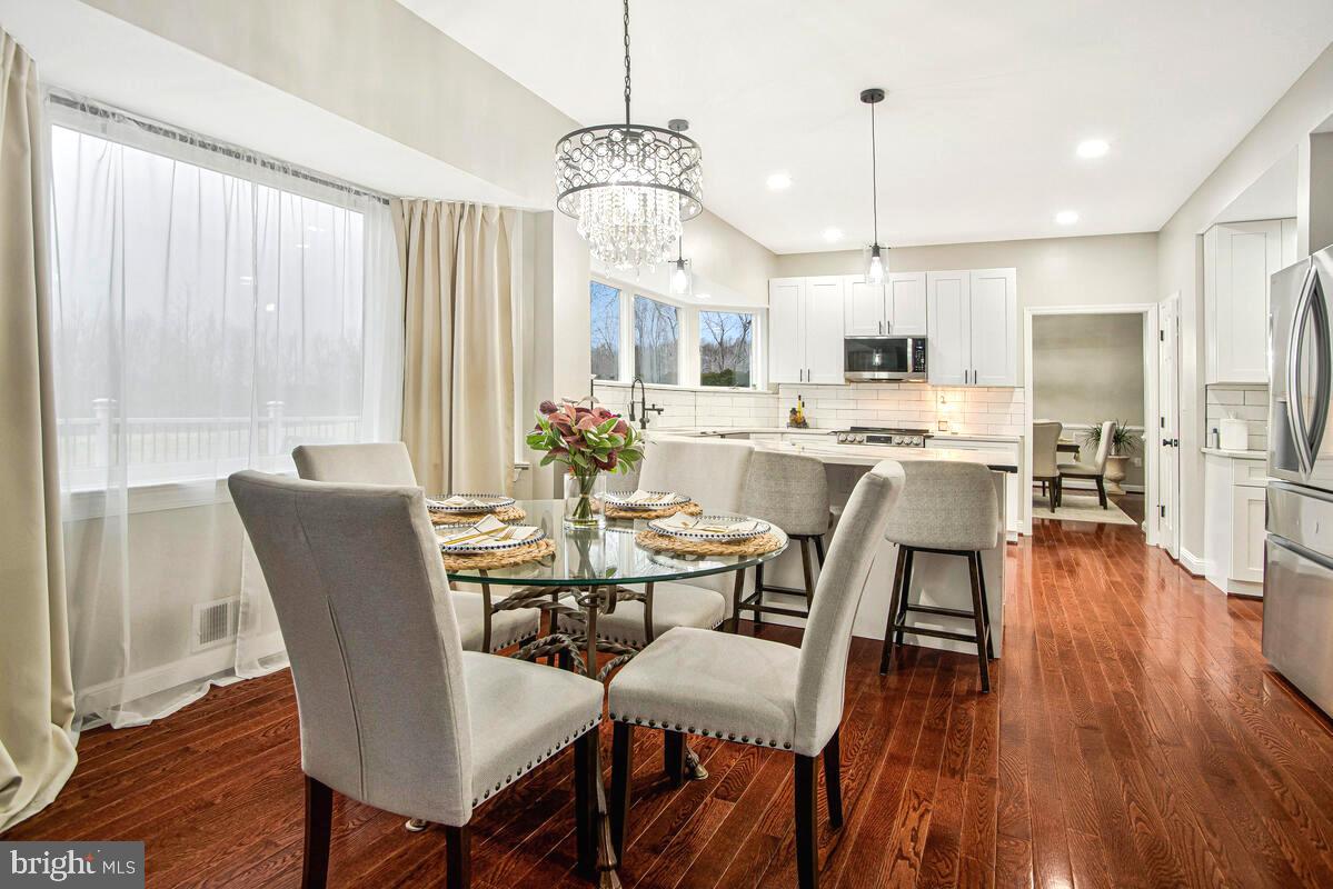 8241 Surratts Road Clinton, MD 20735 - Photo 19 of 55 a view of a dining room with furniture window and wooden floor