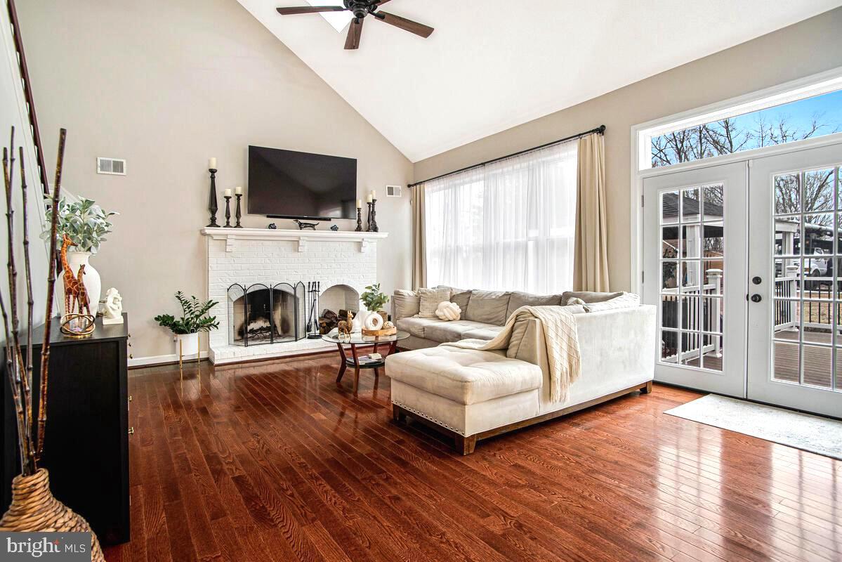 8241 Surratts Road Clinton, MD 20735 - Photo 20 of 55 a living room with fireplace furniture and a flat screen tv
