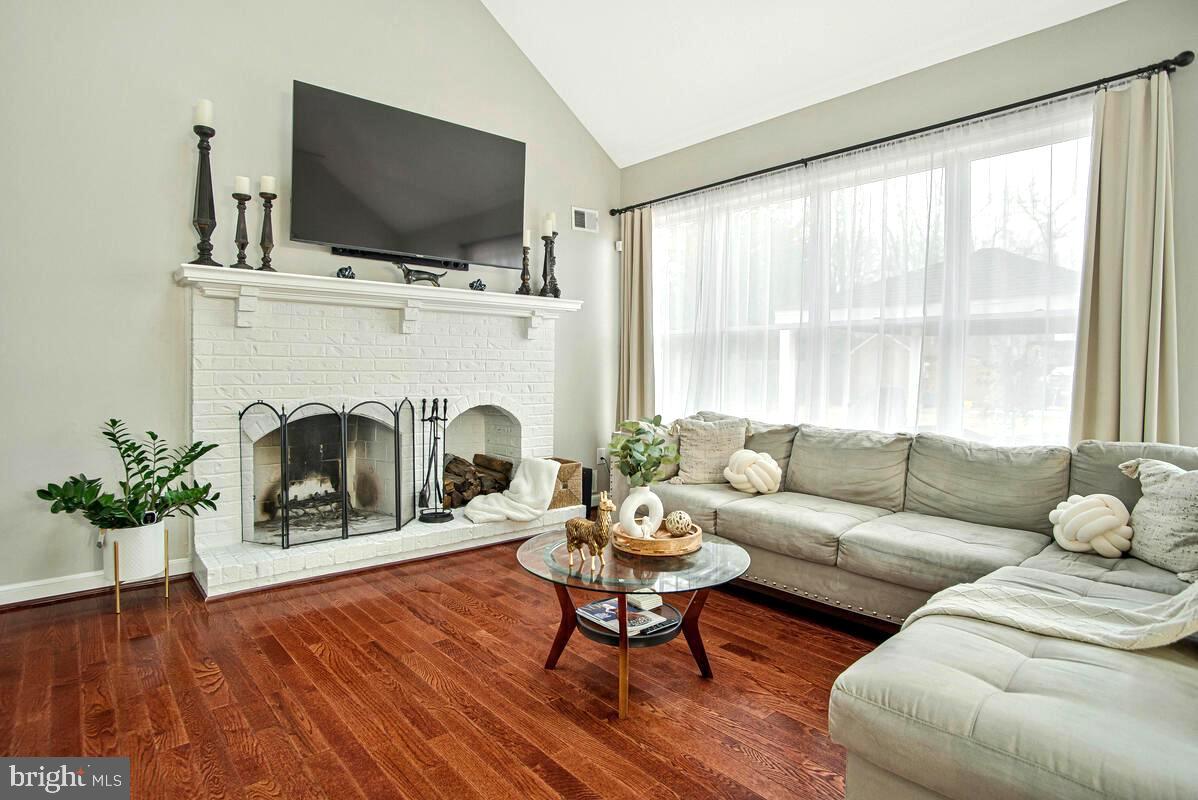 8241 Surratts Road Clinton, MD 20735 - Photo 21 of 55 a living room with furniture a fireplace and a flat screen tv