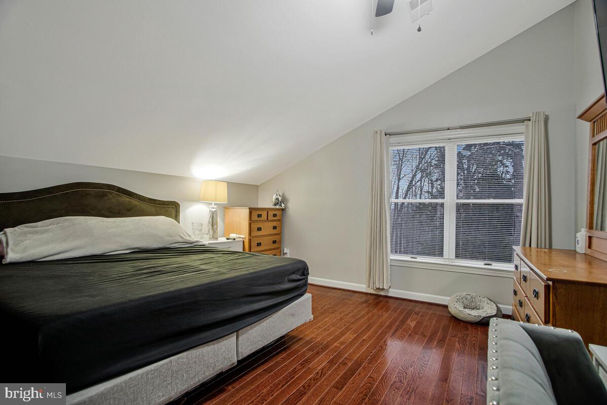 8241 Surratts Road Clinton, MD 20735 - Photo 26 of 55 a bedroom with a bed and wooden floor