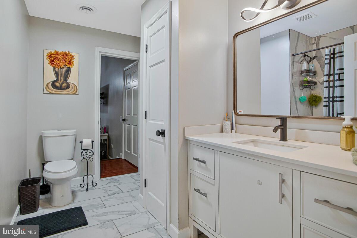 8241 Surratts Road Clinton, MD 20735 - Photo 28 of 55 a spacious bathroom with a toilet sink and shower