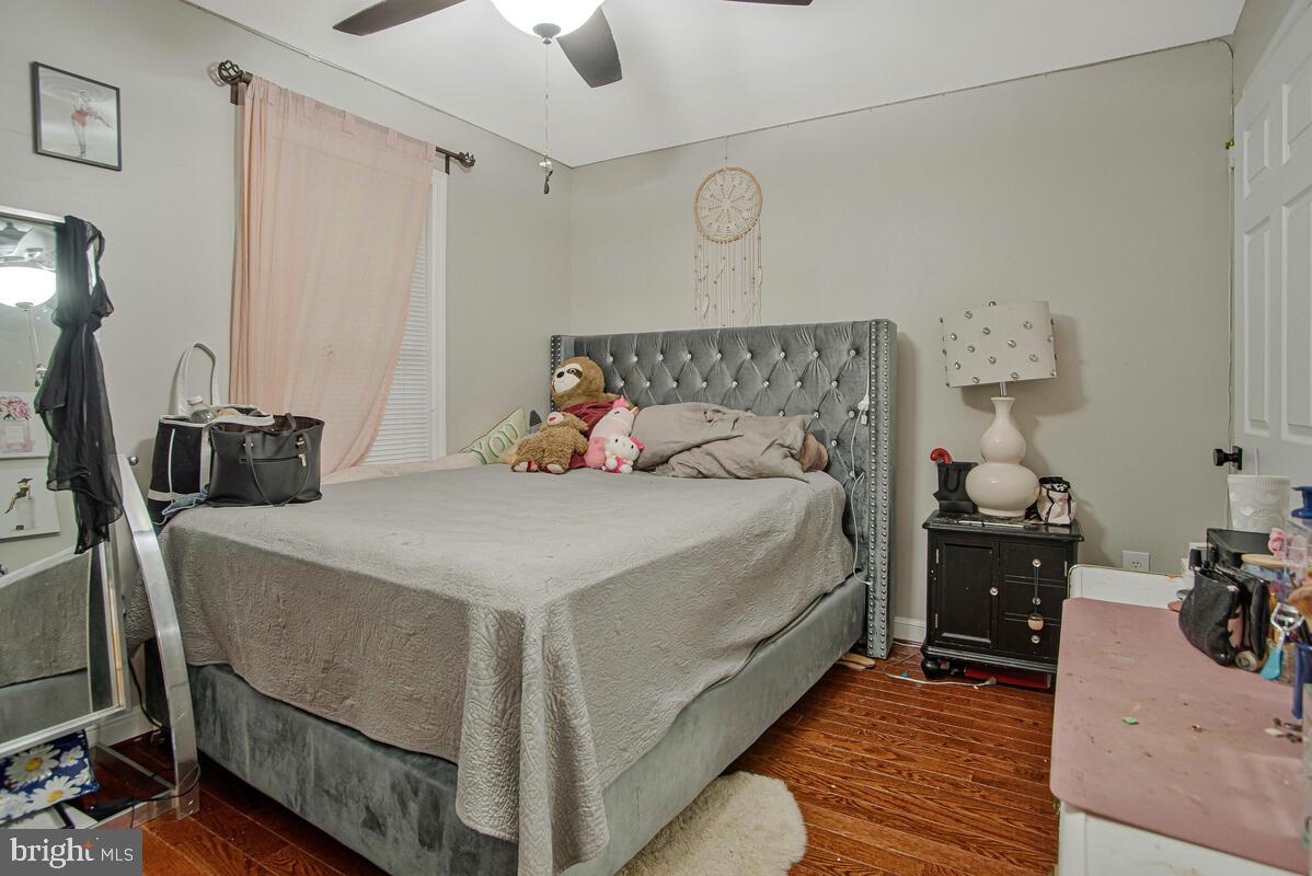 8241 Surratts Road Clinton, MD 20735 - Photo 29 of 55 a bedroom with a bed and a chandelier