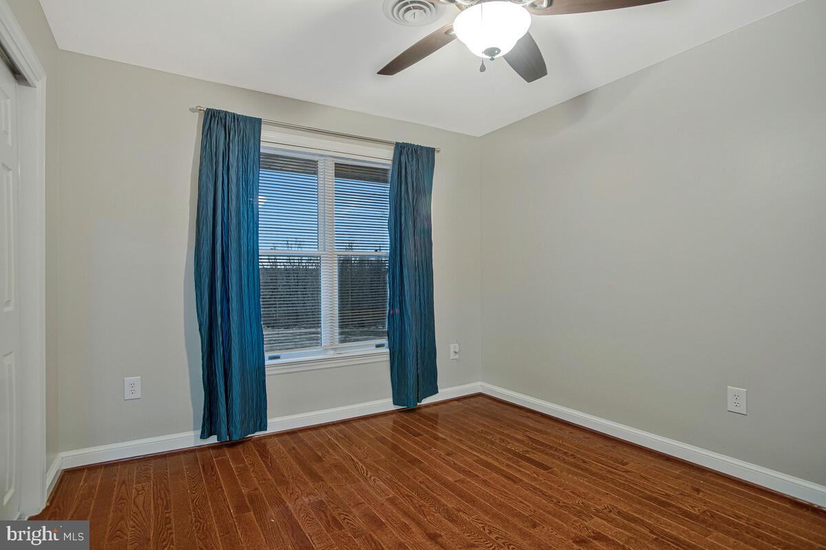 8241 Surratts Road Clinton, MD 20735 - Photo 30 of 55 a view of an empty room with wooden floor and a window