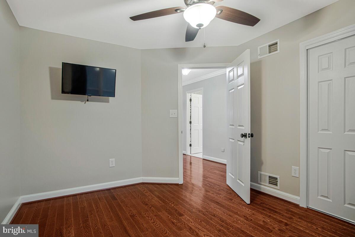 8241 Surratts Road Clinton, MD 20735 - Photo 31 of 55 an empty room with wooden floor and windows