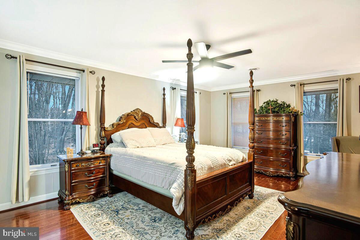 8241 Surratts Road Clinton, MD 20735 - Photo 32 of 55 a bedroom with a bed and wooden floor