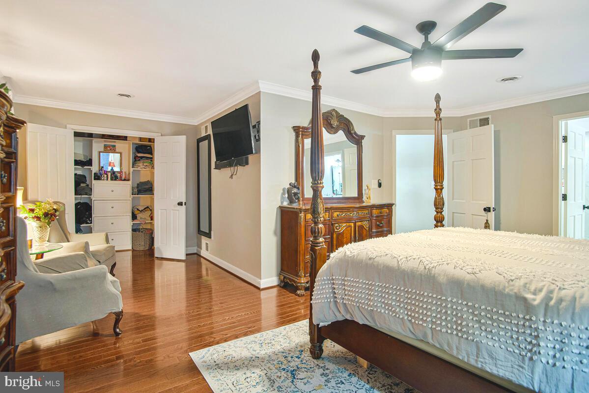 8241 Surratts Road Clinton, MD 20735 - Photo 33 of 55 a bedroom with a bed a large window and wooden floor