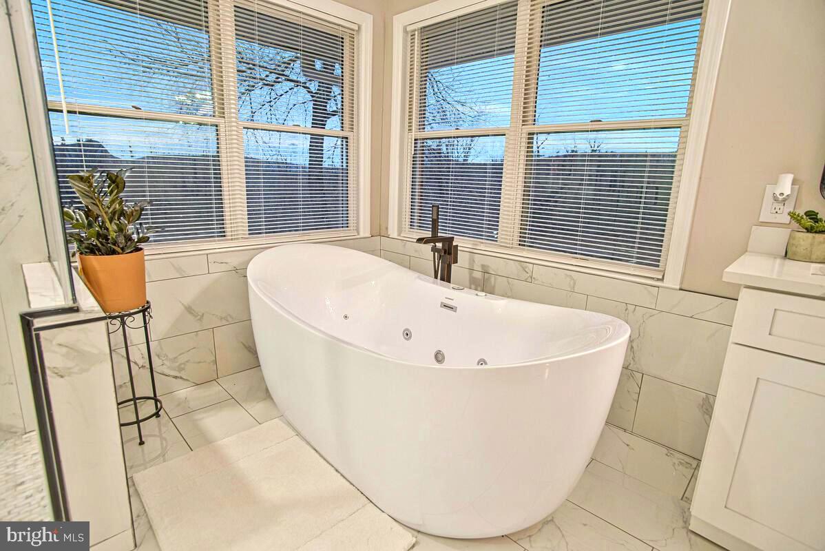 8241 Surratts Road Clinton, MD 20735 - Photo 40 of 55 a white bath tub sitting next to a window