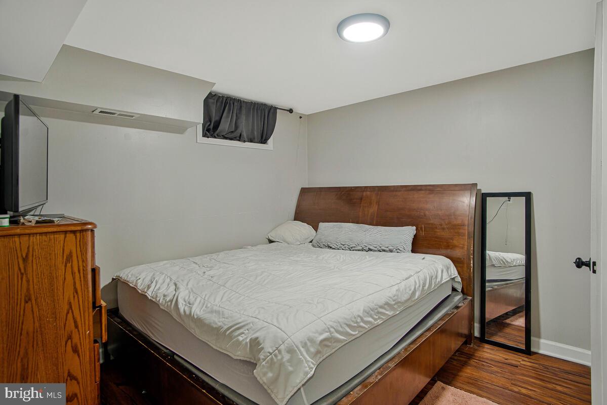 8241 Surratts Road Clinton, MD 20735 - Photo 46 of 55 a bedroom with a bed and wooden floor