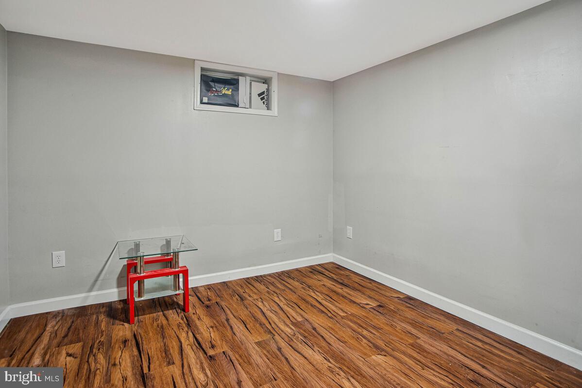 8241 Surratts Road Clinton, MD 20735 - Photo 48 of 55 a room with wooden floor and utility