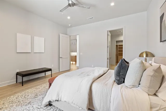 a bedroom with a bed and a lamp