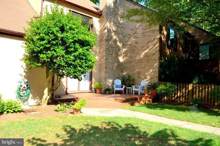 10911 Knights Bridge Court Reston, VA 20190 - Photo 12 of 30 a view of backyard with table and chairs and potted plants