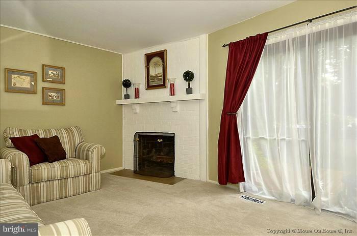 10911 Knights Bridge Court Reston, VA 20190 - Photo 13 of 30 a living room with furniture and a fireplace