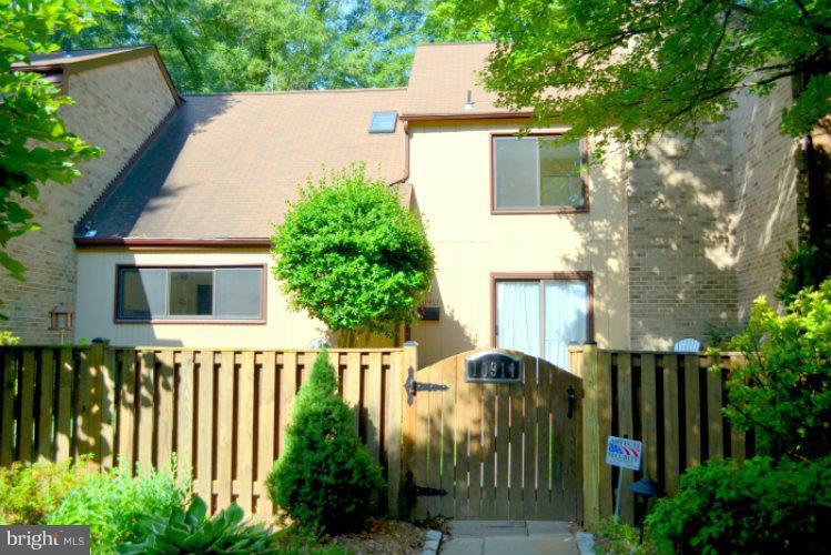 10911 Knights Bridge Court Reston, VA 20190 - Photo 30 of 30 a view of a house with brick wall and plants