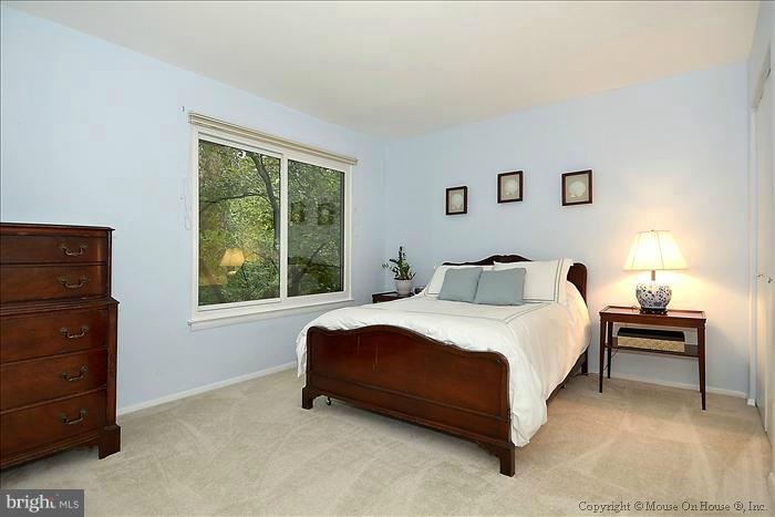 10911 Knights Bridge Court Reston, VA 20190 - Photo 9 of 30 a spacious bedroom with a bed and window
