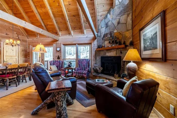 a living room with furniture a fireplace and potted plants