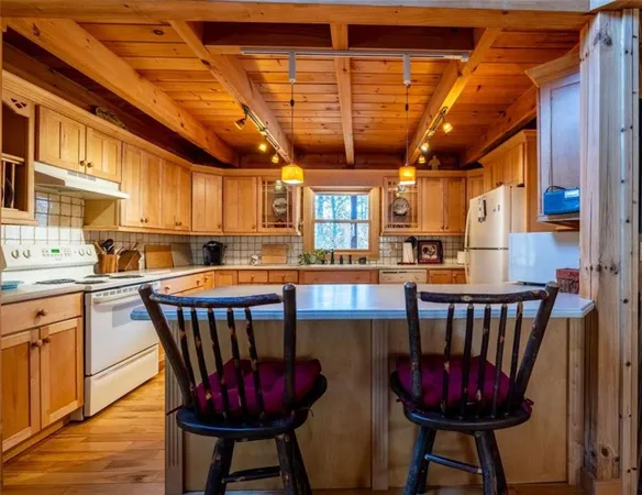 a kitchen with a dining table and chairs